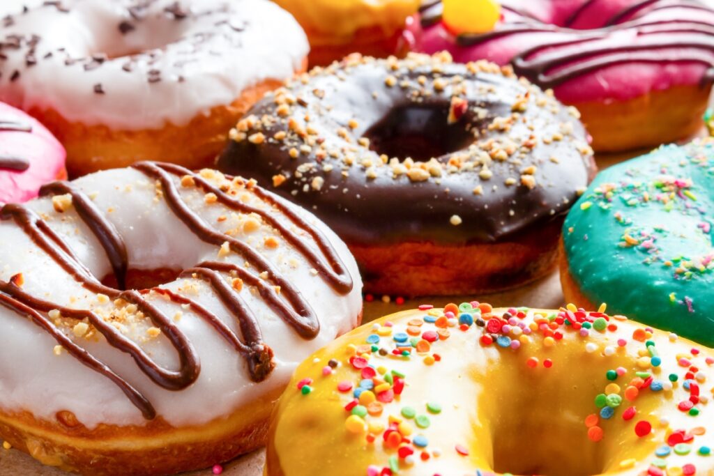 A table full of doughnuts with colorful glacing