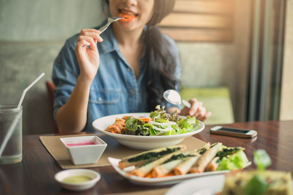 Closeup of a woman eating healthy salad
