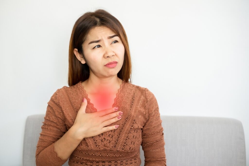 woman in pain with heartburn and headache