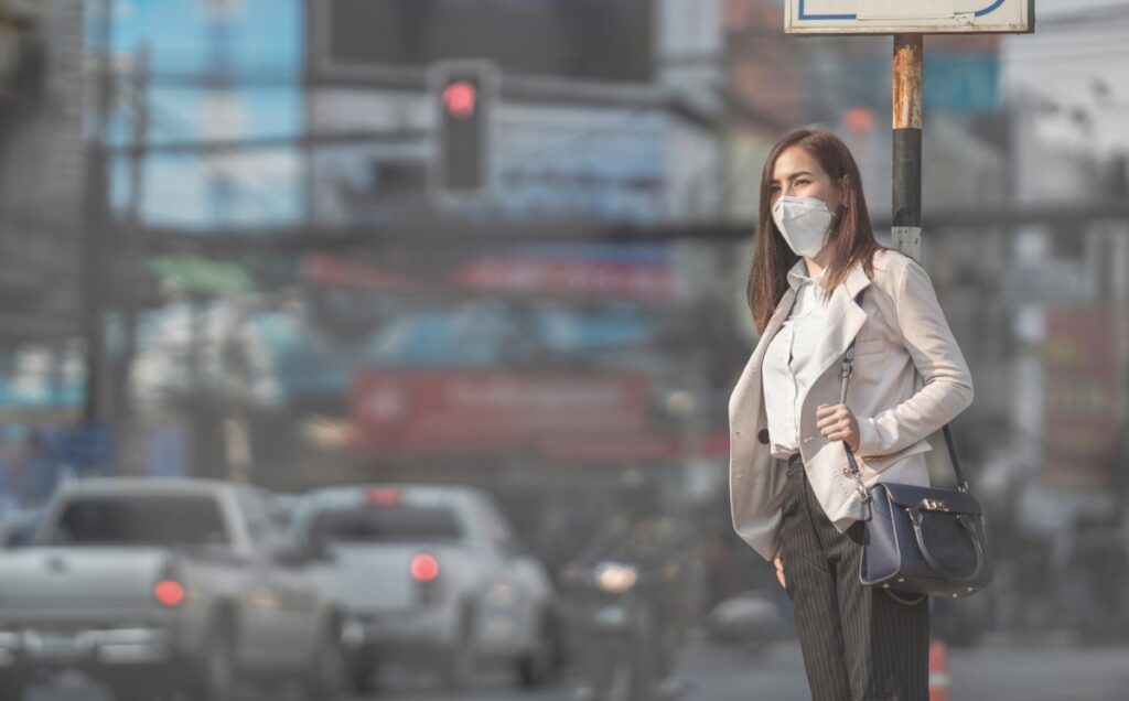 woman in the street with air polluted