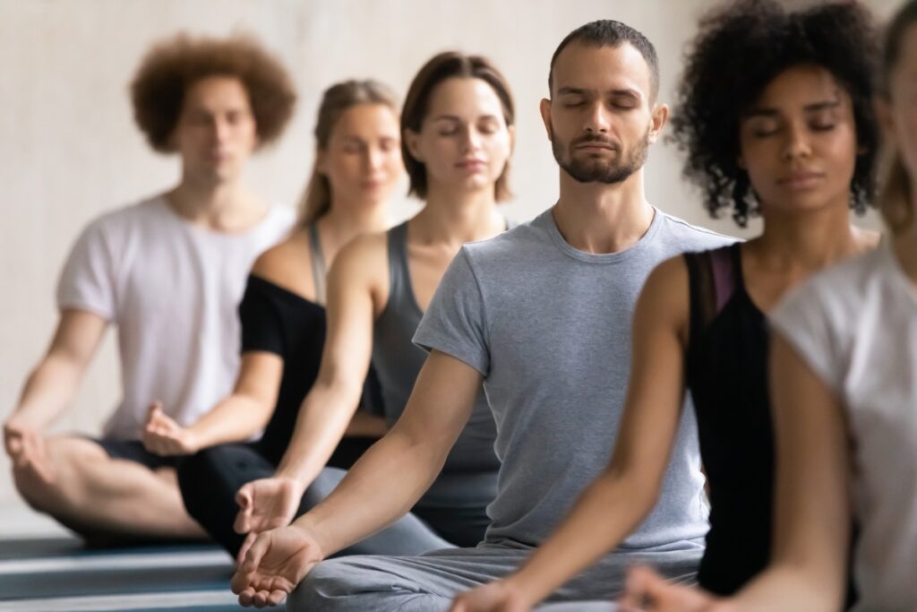 group meditating to improve stress resilience