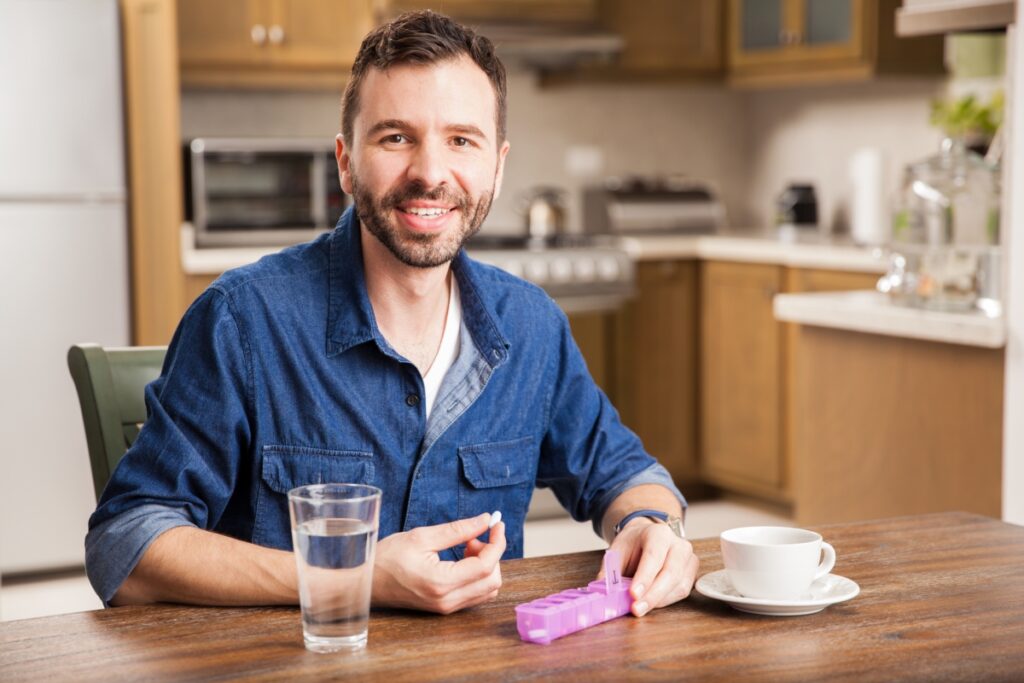 male patient taking his medicine on schedule