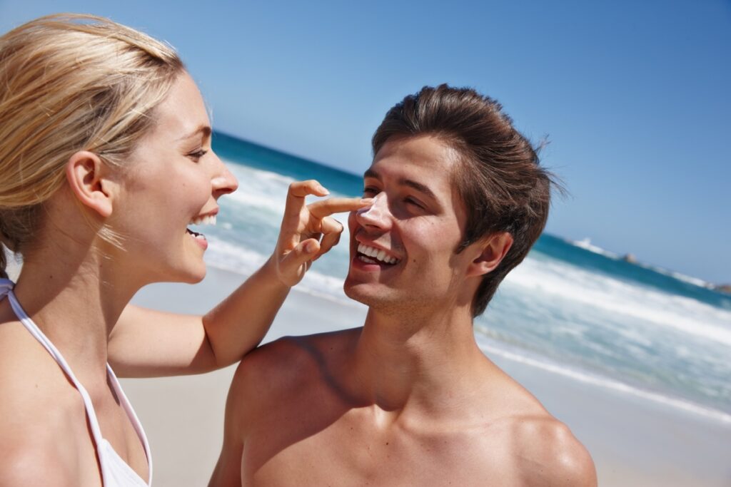 couple applying suncreen