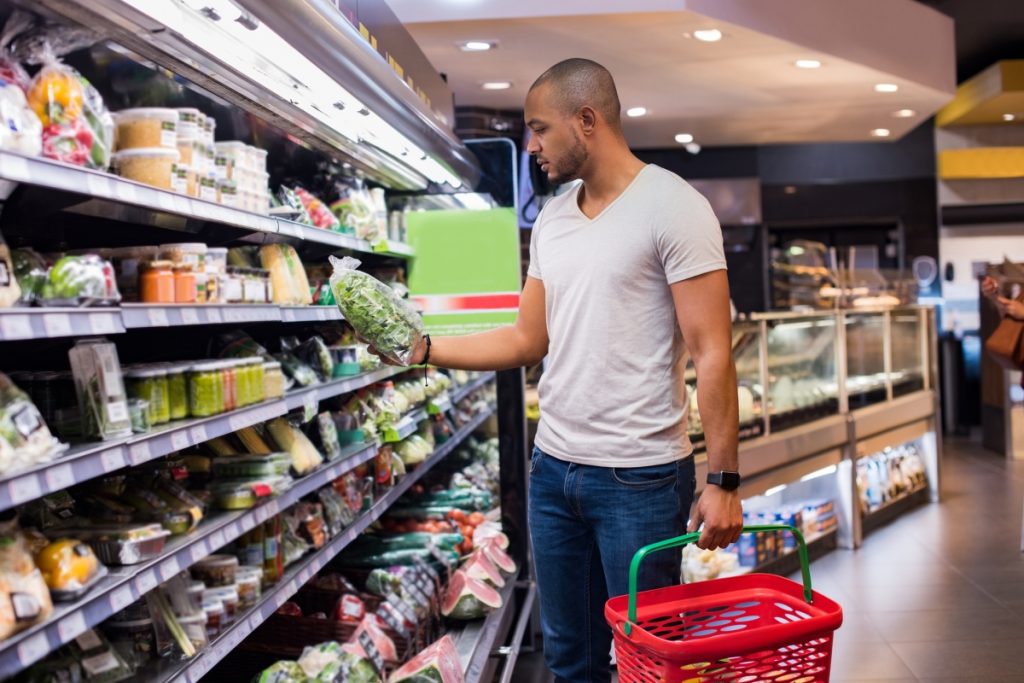 Man shopping veggies at supermarket.