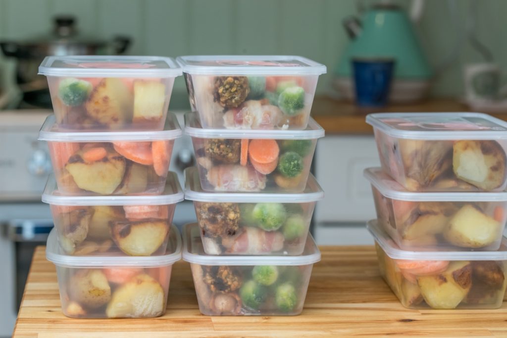 Meal prep. Stack of home cooked roast chicken dinners in containers ready to be frozen for later use as quick and easy ready meals.