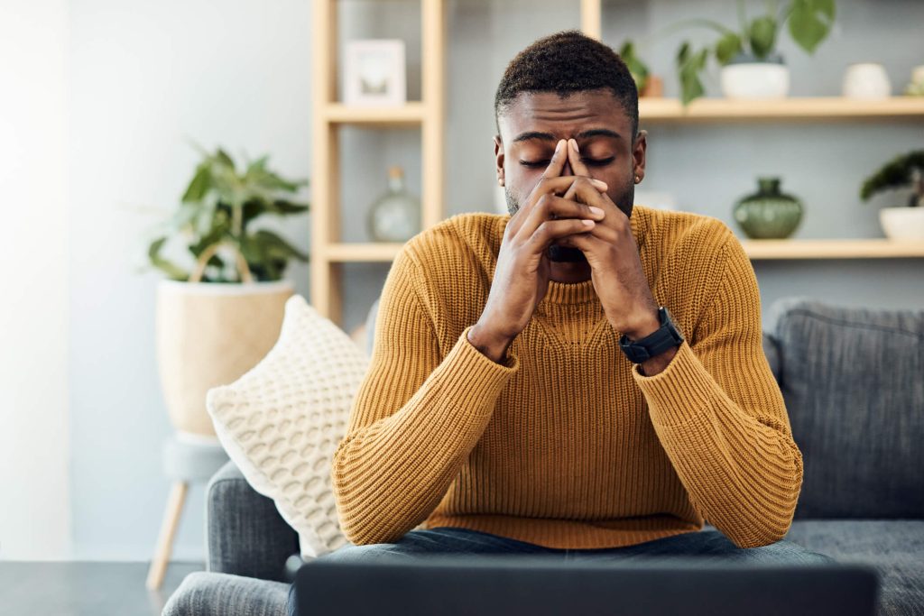 Young man looking stressed out at home