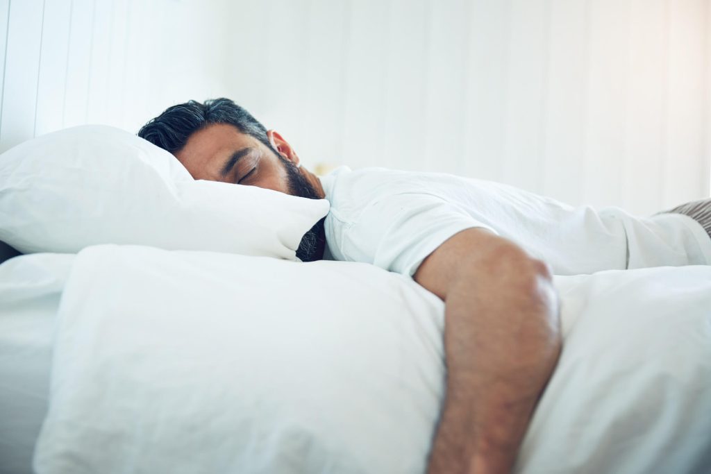 Shot of a mature man lying on his bed and sleeping.