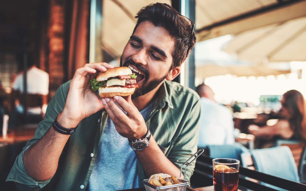 man happy eating a burger