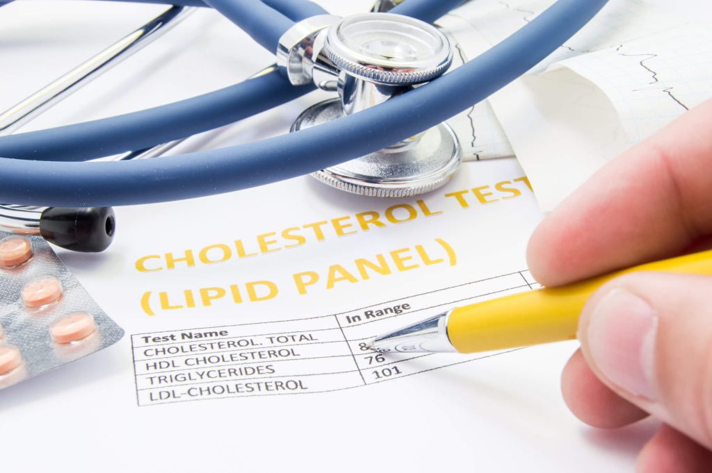 General health practitioner checks cholesterol levels in patient test results on blood lipids