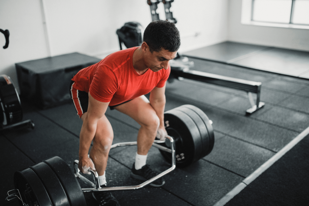 man doing a deadlift at the gym