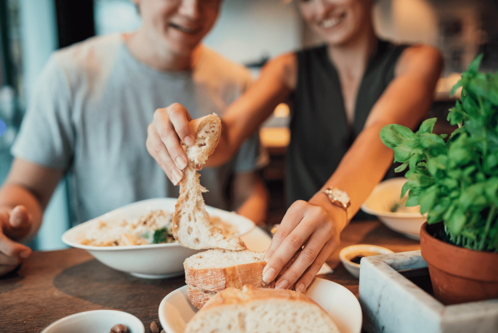 couple eating pasta and bread
