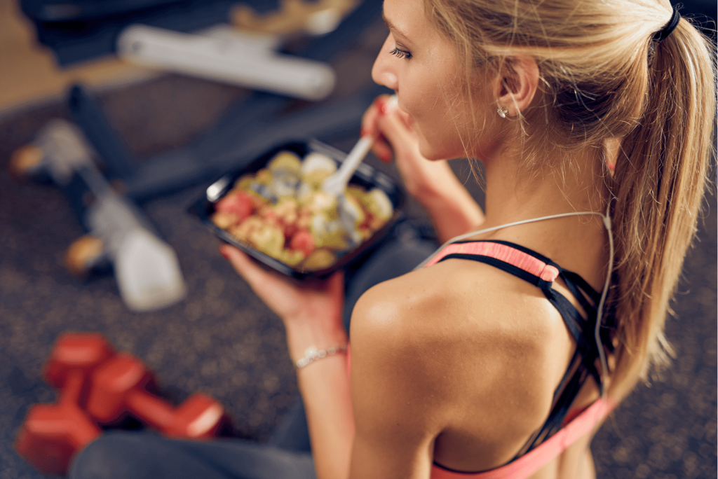 woman eating prepared food from a container 