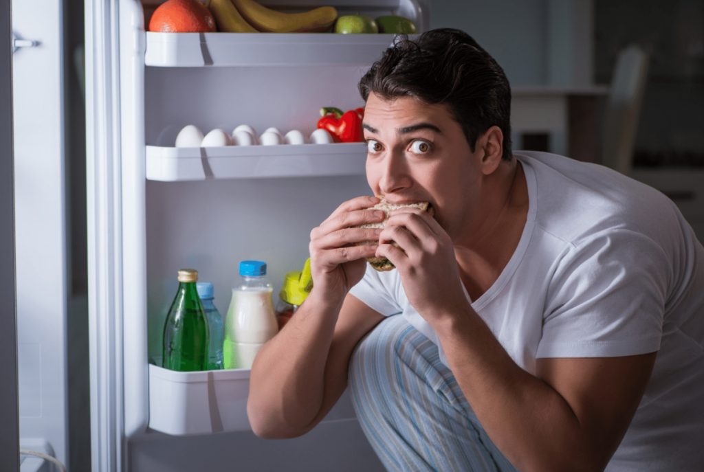 men eating sandwich in the middle of the night