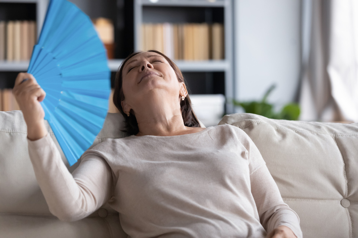 Relaxed middle-aged woman sit rest on comfortable couch