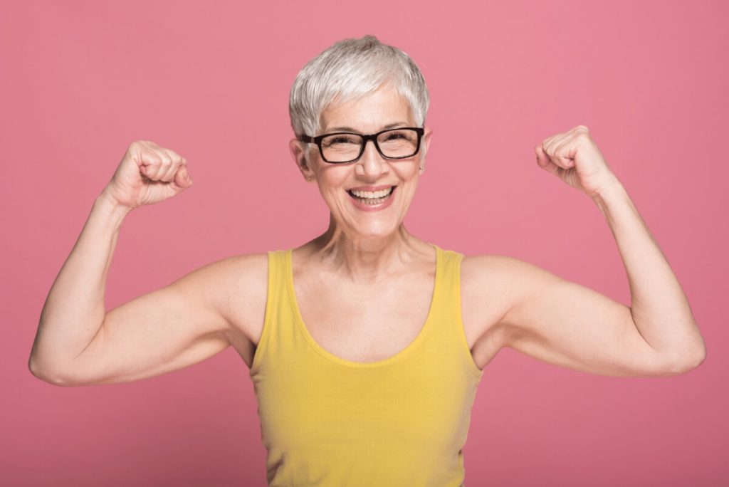 older woman doing a double bicep pose