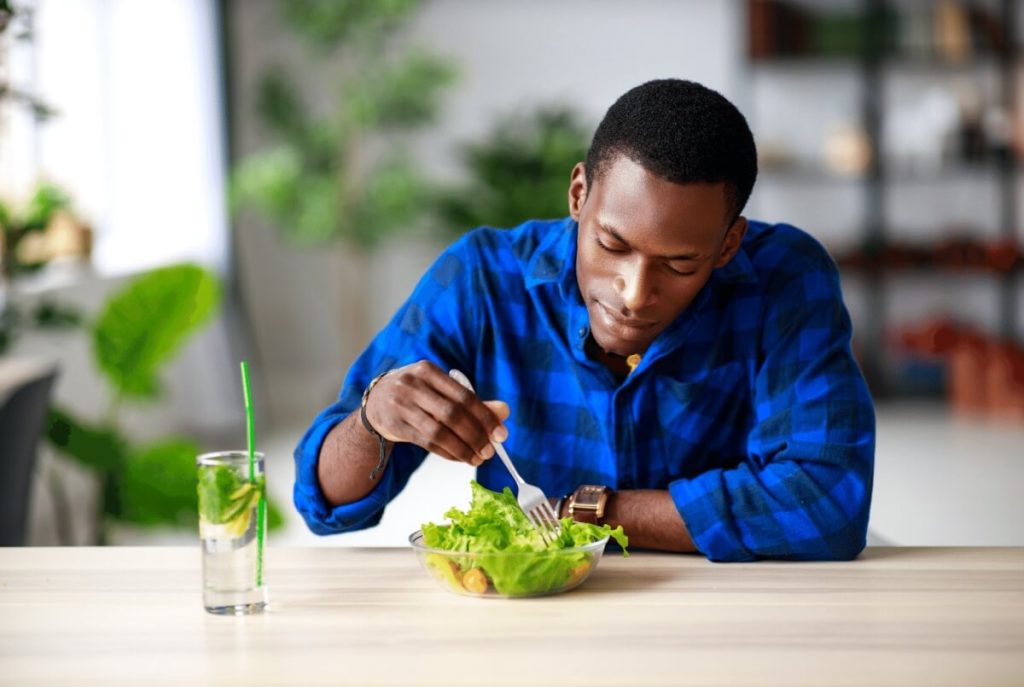 man eating a salad