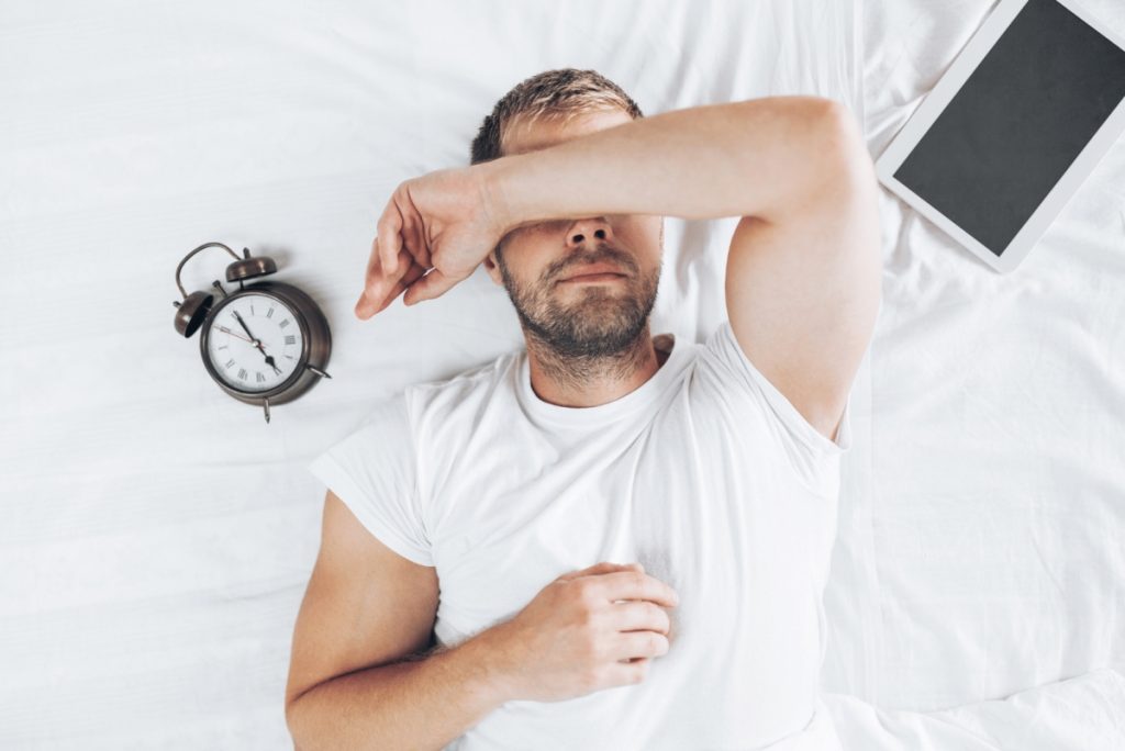 man napping with his arm around this eyes