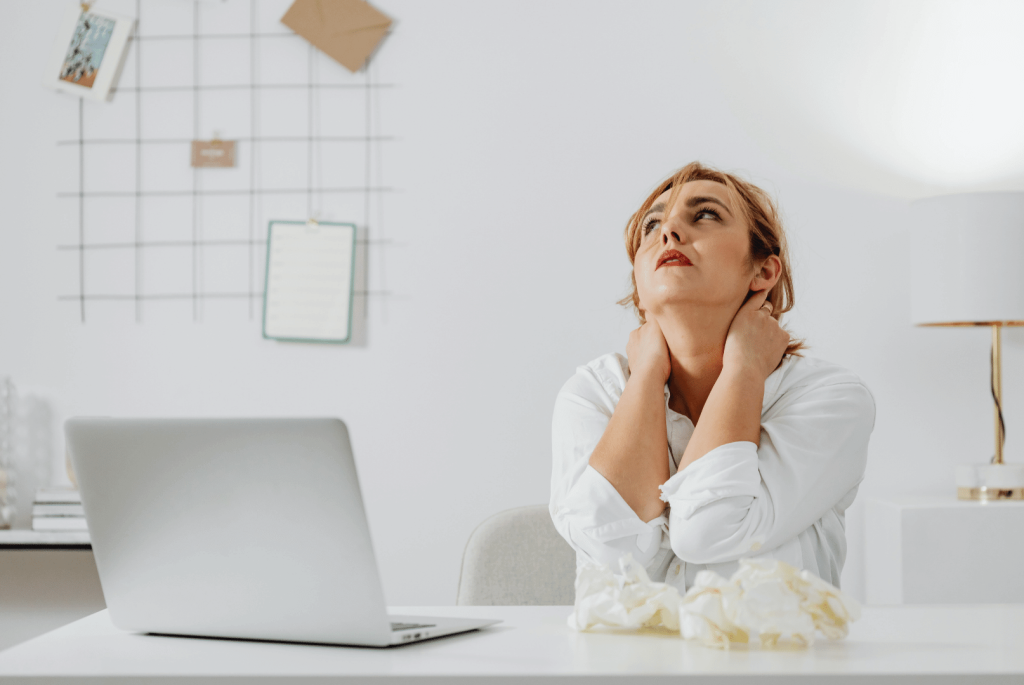 stressed woman with hands on her neck