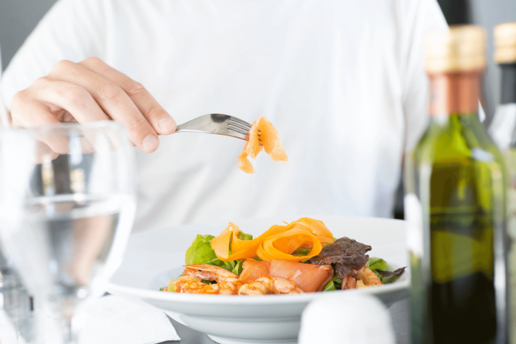 close up of eating a salad with salmon