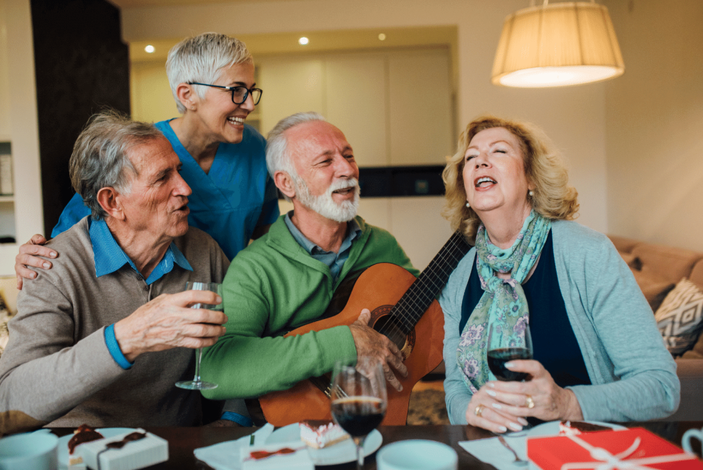a group of elderly people singing after having dinner 