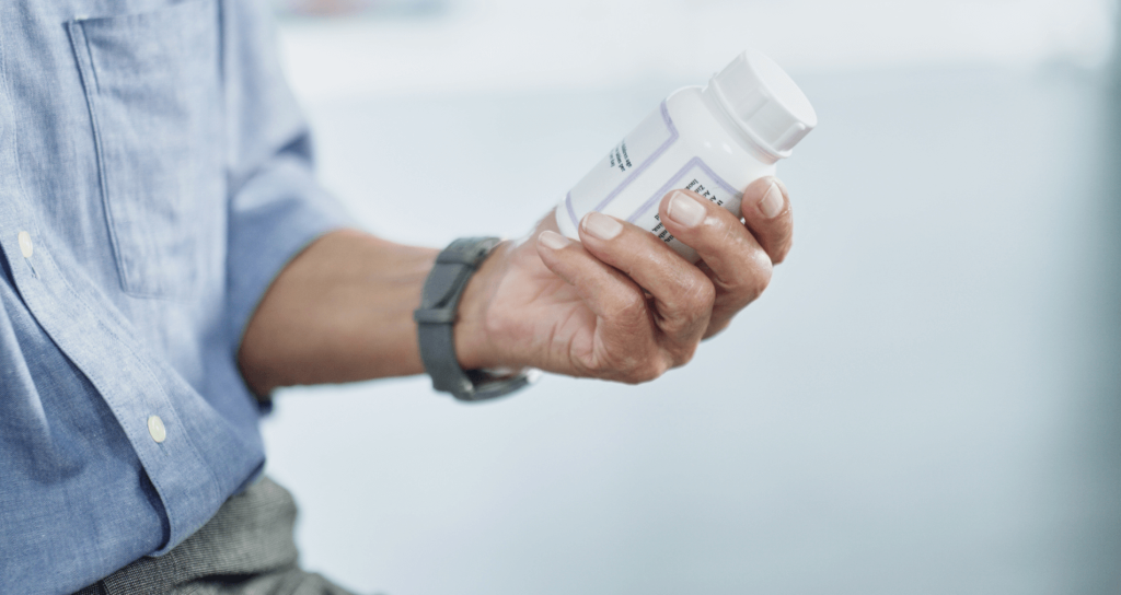 man holding a bottle of magnesium