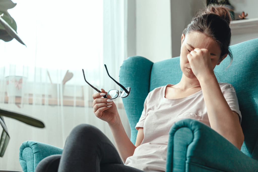 woman fatigue sitting in a blue chair