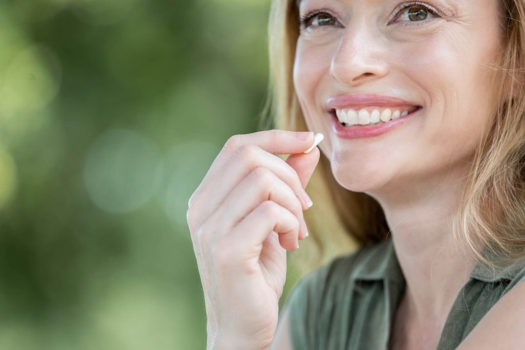 white woman taking a p3om pill