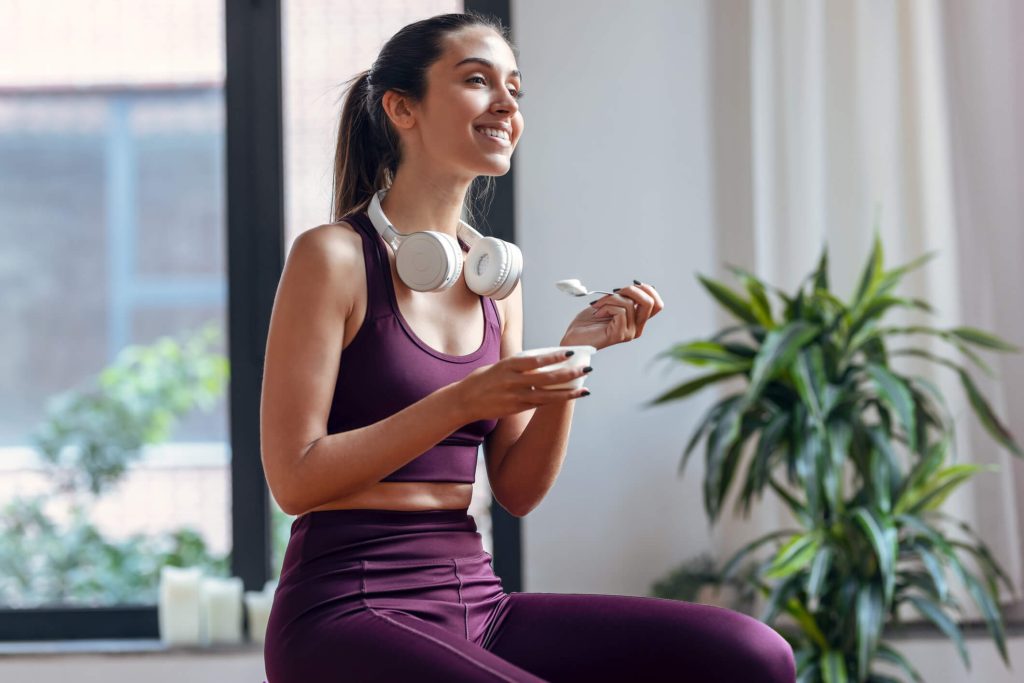 fitness woman eating yogurt