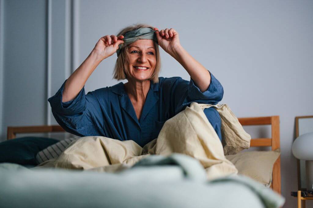 older woman waking up happy