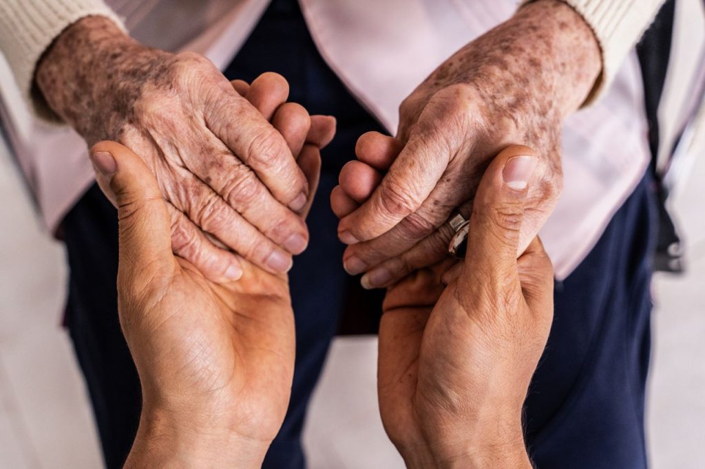 holding hands of elder woman