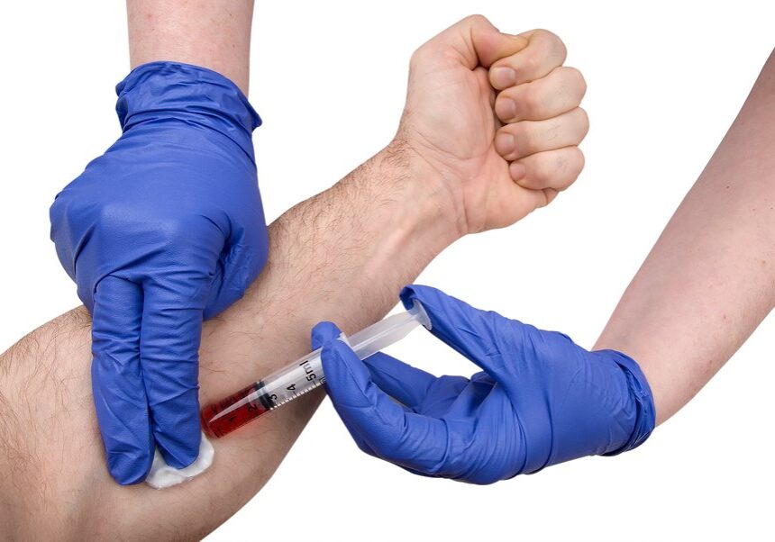 Close up of doctor or nurse and patient getting blood drawn.