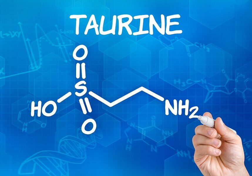 Hand with pen drawing the chemical formula of taurine