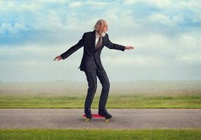 energetic senior man enjoying riding a skateboard