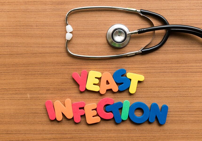 yeast infection colorful word with stethoscope on wooden background