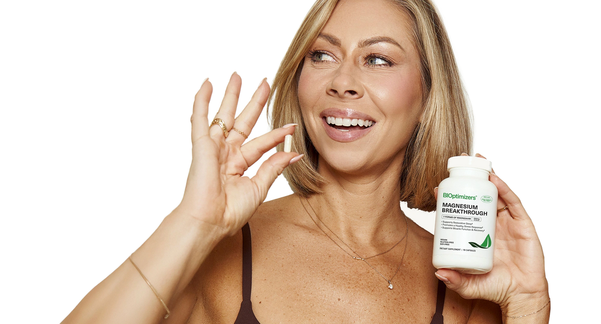 Woman holding Magnesium Breakthrough bottle