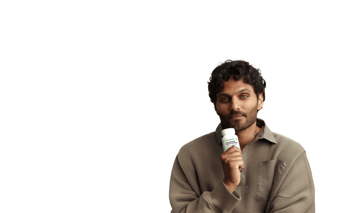 Jay Shetty holding a bottle of Magnesium Breakthrough